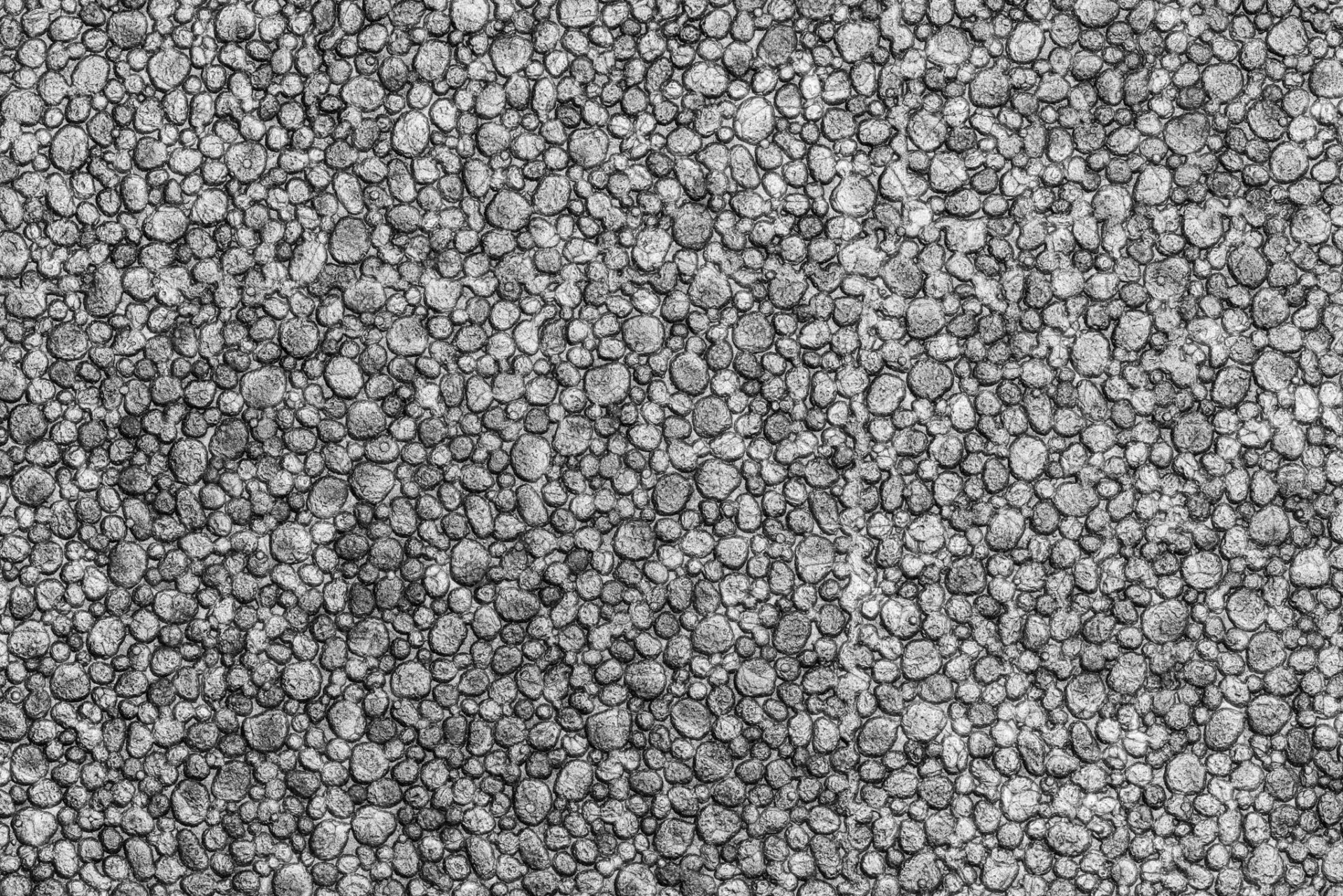 Black color styrofoam texture background. Close-up of abstract plastic material pattern